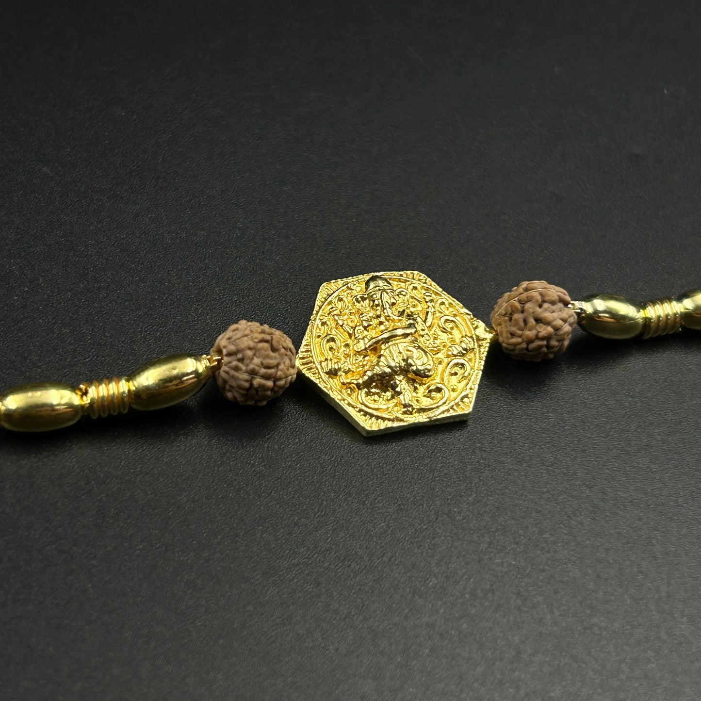 Yellow Gold Ganpati Rakhi with Rudraksh